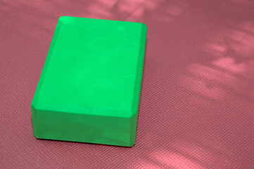 pink yoga mat and green block