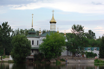 Orthodox church near the river on the sky background