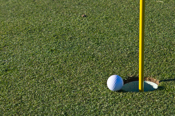 Golf ball almost in the hole