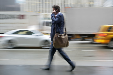 motion blurred business people walking on the street