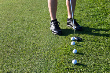 Golfer putting the golf ball