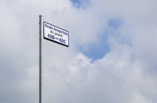 Street signpost along a rural road in Ilfov County with sky on b