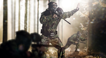 Fototapeta premium Paintball team in action forest location