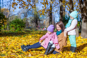 Fototapeta premium Little girls and young mother in autumn park