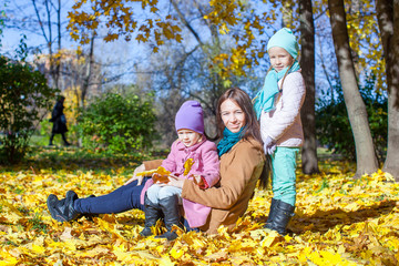 Fototapeta premium Little girls and young mother in autumn park