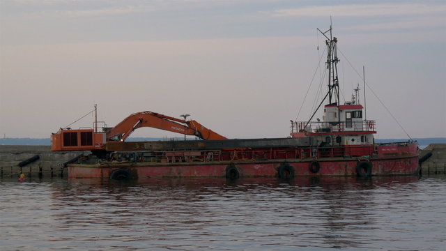 An old excavator on dock on the sea of Estonia GH4 4K UHD