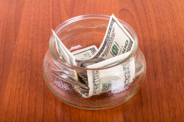 Dollar Banknotes in Glass Bowl
