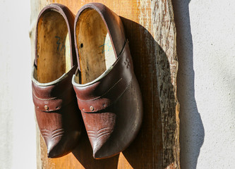 traditional wooden shoes hanging on a wall