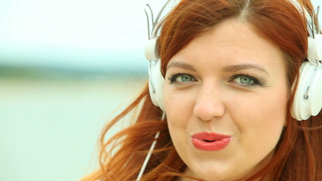 Woman on Beach Listening to Music