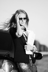 Fashion business woman with financial papers at the car