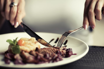 Female hands with a dinner at restaurant