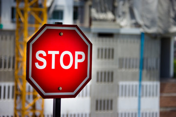 Stop sign Construction site background.