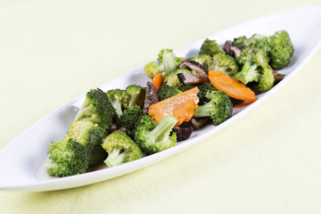 Three vegetables (broccoli, mushroom, carrot) on the plate
