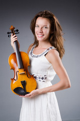 Woman artist with violin in music concept
