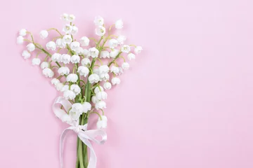 Foto op Plexiglas Lilly of the valley flowers on bright pink background. © agneskantaruk