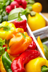 Colorful peppers in a wooden box