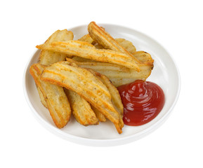 Cooked potato wedges in dish with ketchup