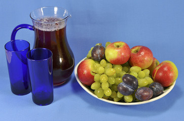 Jug with juice and fruit on a platter