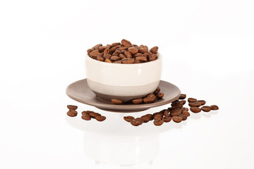 pile of coffee beans on cup isolated on white background