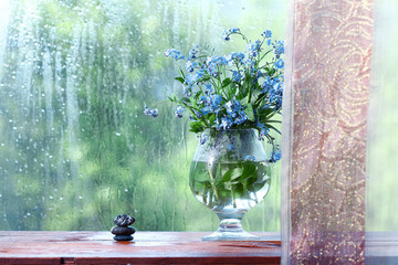 vase with forget-me on the window