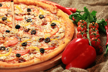 pizza with vegetables and herbs rustic background
