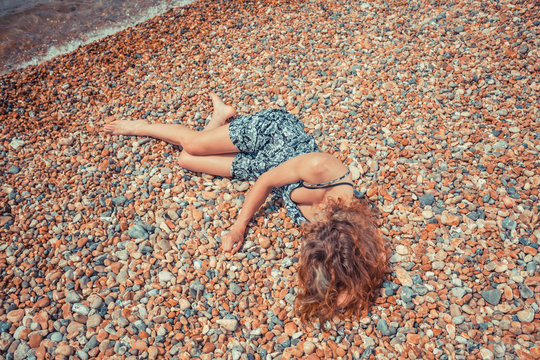 Young woman lying on the beach