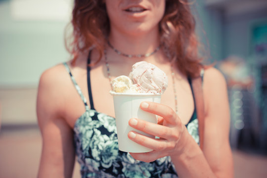 Woman eating ice cream on the beach