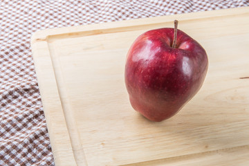 Red ripe apple on wood