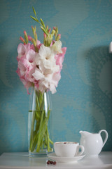beautiful gladiolus bouquet and coffee cup