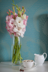 beautiful gladiolus bouquet  and coffee cup