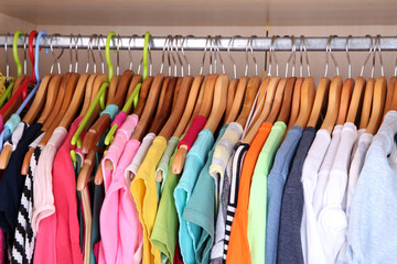 Fototapeta premium Colorful clothes hanging in wardrobe