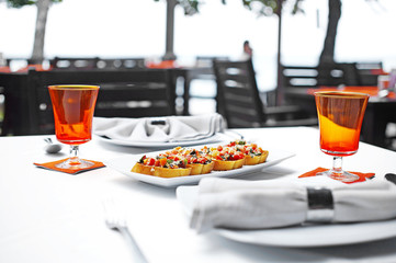 close up french bread and vegetable sauce on white dish