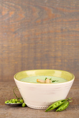 Tasty peas soup on wooden table