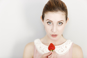 Woman eating a strawberry