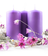 Candles with dried flowers isolated on white