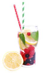 Glass of berry cocktail with lemon and mint