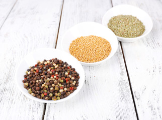 Spice in round bowls on wooden background