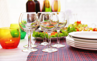 Buffet table with dishware waiting for guests