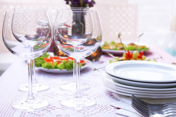Buffet table with dishware waiting for guests