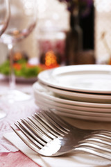 Buffet table with dishware waiting for guests