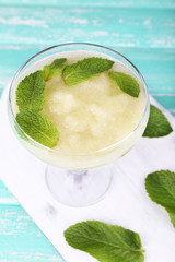 Melon smoothie in glass on table close-up