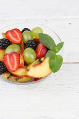 fresh tasty fruit salad on wooden table