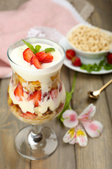 Natural yogurt with fresh berries on wooden table