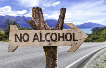 No Alcohol wooden sign with a street background