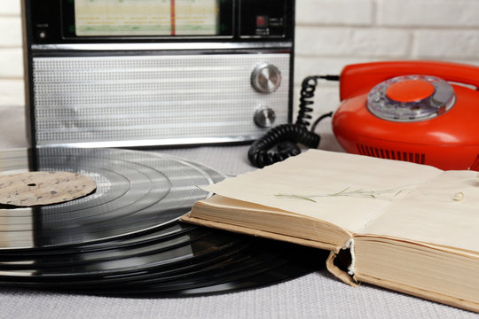 Retro composition with old phone, radio and books, close up