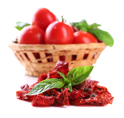 Sun dried tomatoes, fresh tomatoes in wicker basket,  basil