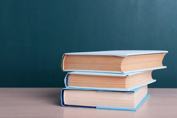 Books on table on board background