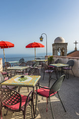 Rooftop sitting area and church bell tower in Castelmola, Sicily
