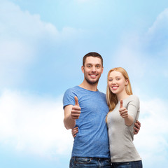 smiling couple showing thumbs up