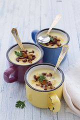 Potato cream soup with wild mushrooms in the colored cups